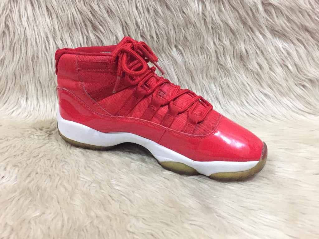 Nike Air Jordan 11 Retro “Win Like '96” sneakers in a gym red, black, and white colorway. 