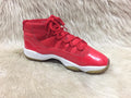 Nike Air Jordan 11 Retro “Win Like '96” sneakers in a gym red, black, and white colorway. 
