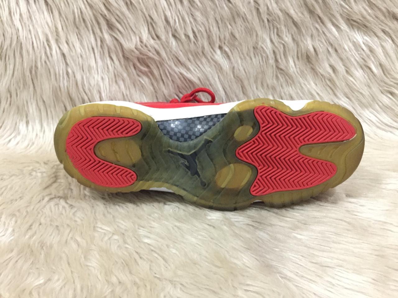 Nike Air Jordan 11 Retro “Win Like '96” sneakers in a gym red, black, and white colorway. 