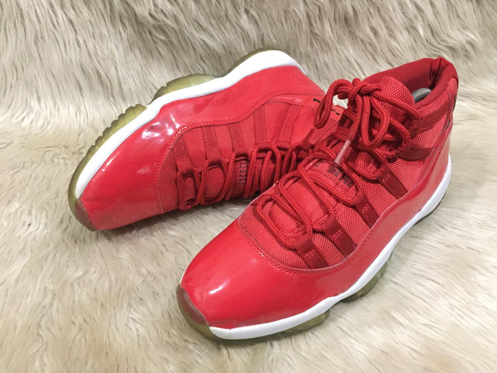 Nike Air Jordan 11 Retro “Win Like '96” sneakers in a gym red, black, and white colorway. 