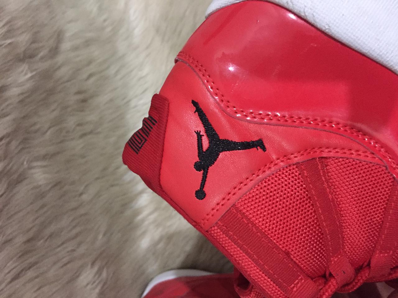 Nike Air Jordan 11 Retro “Win Like '96” sneakers in a gym red, black, and white colorway. 