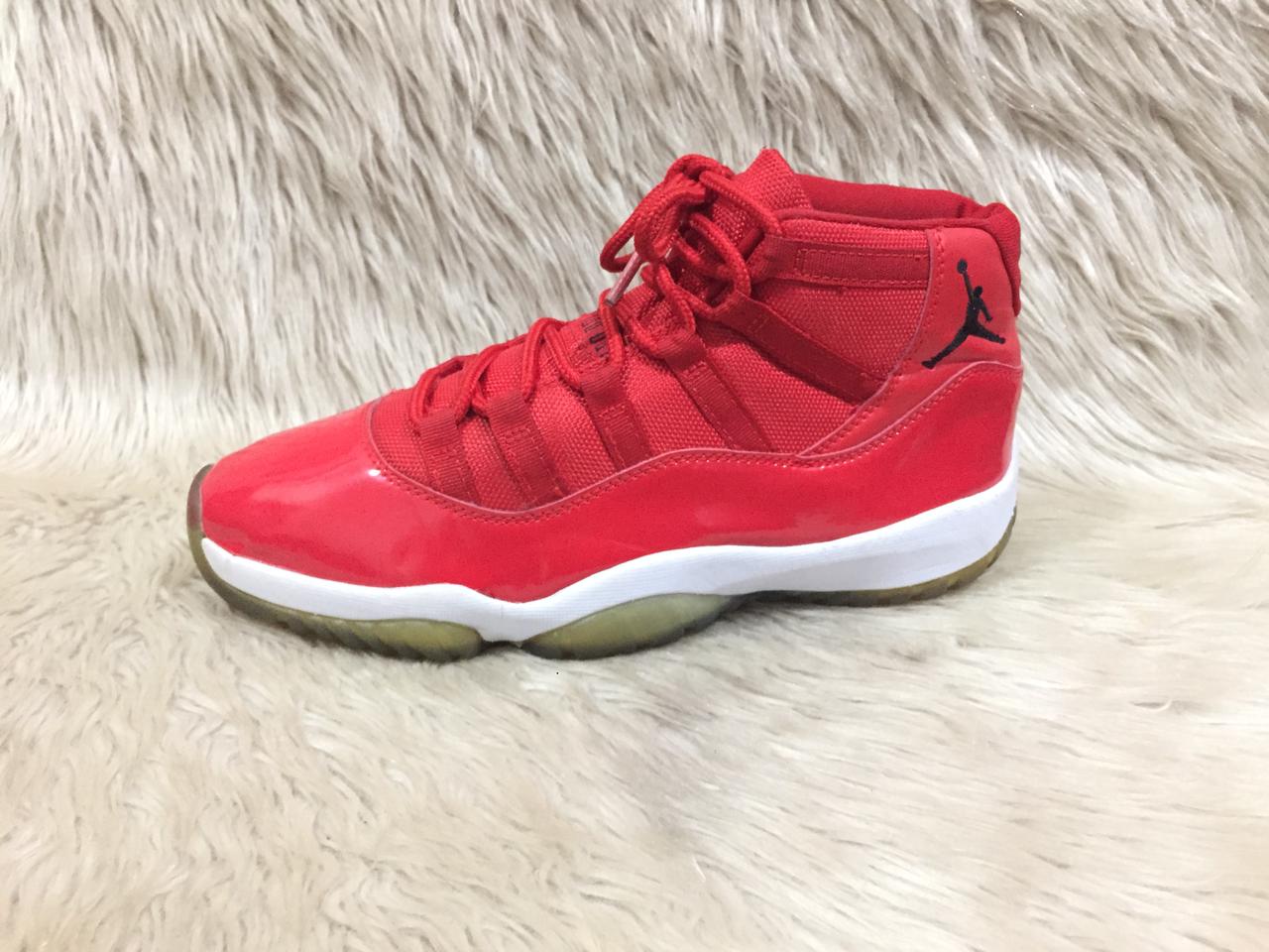 Nike Air Jordan 11 Retro “Win Like '96” sneakers in a gym red, black, and white colorway. 