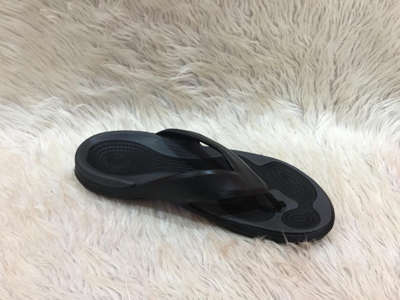 black and gray Crocs flip-flops