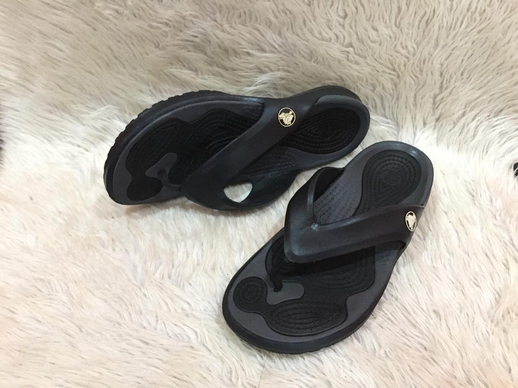 black and gray Crocs flip-flops